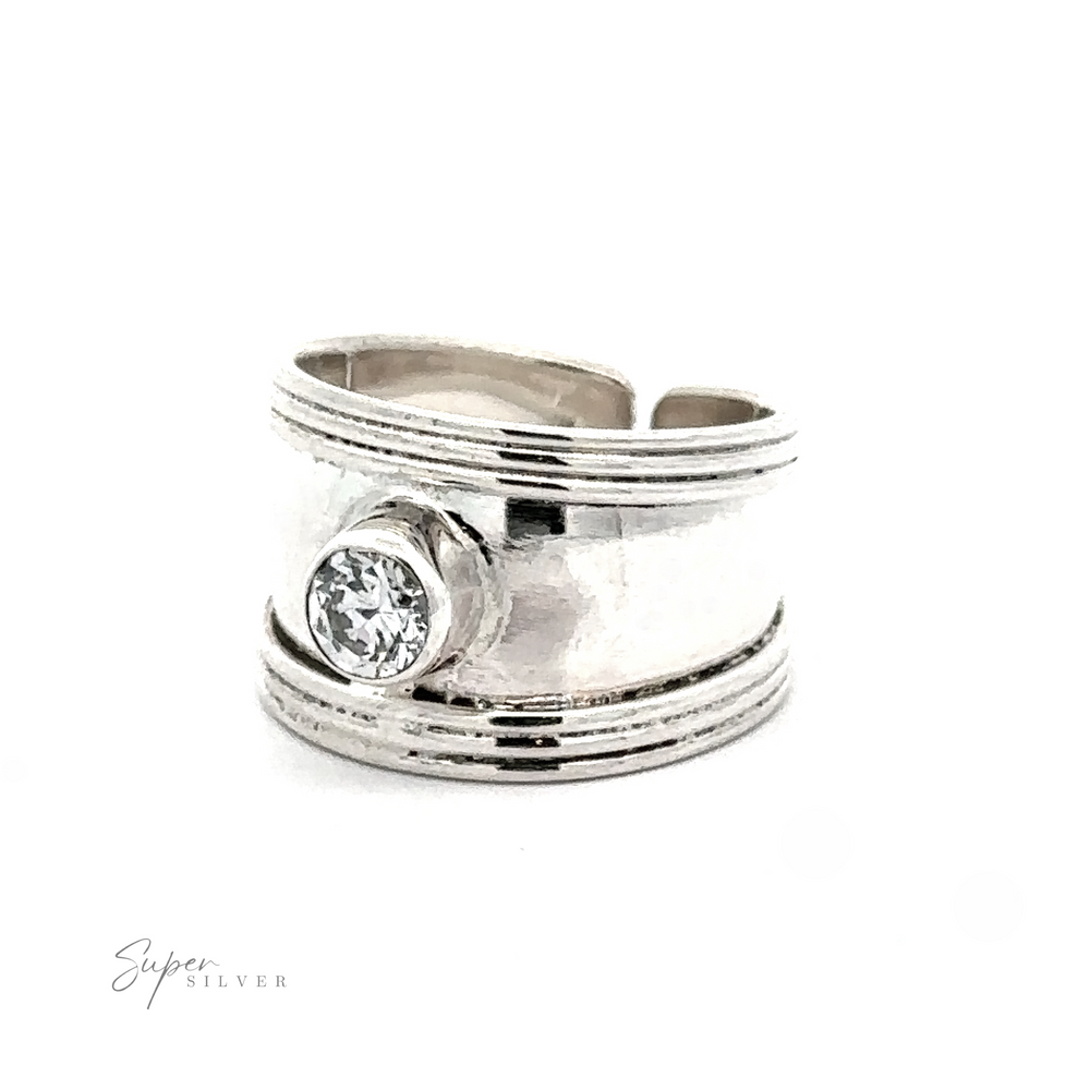 
                  
                    Adjustable Wide Cigar Band Toe Ring with Gemstone featuring a prominent, round-cut crystal, photographed on a white background.
                  
                
