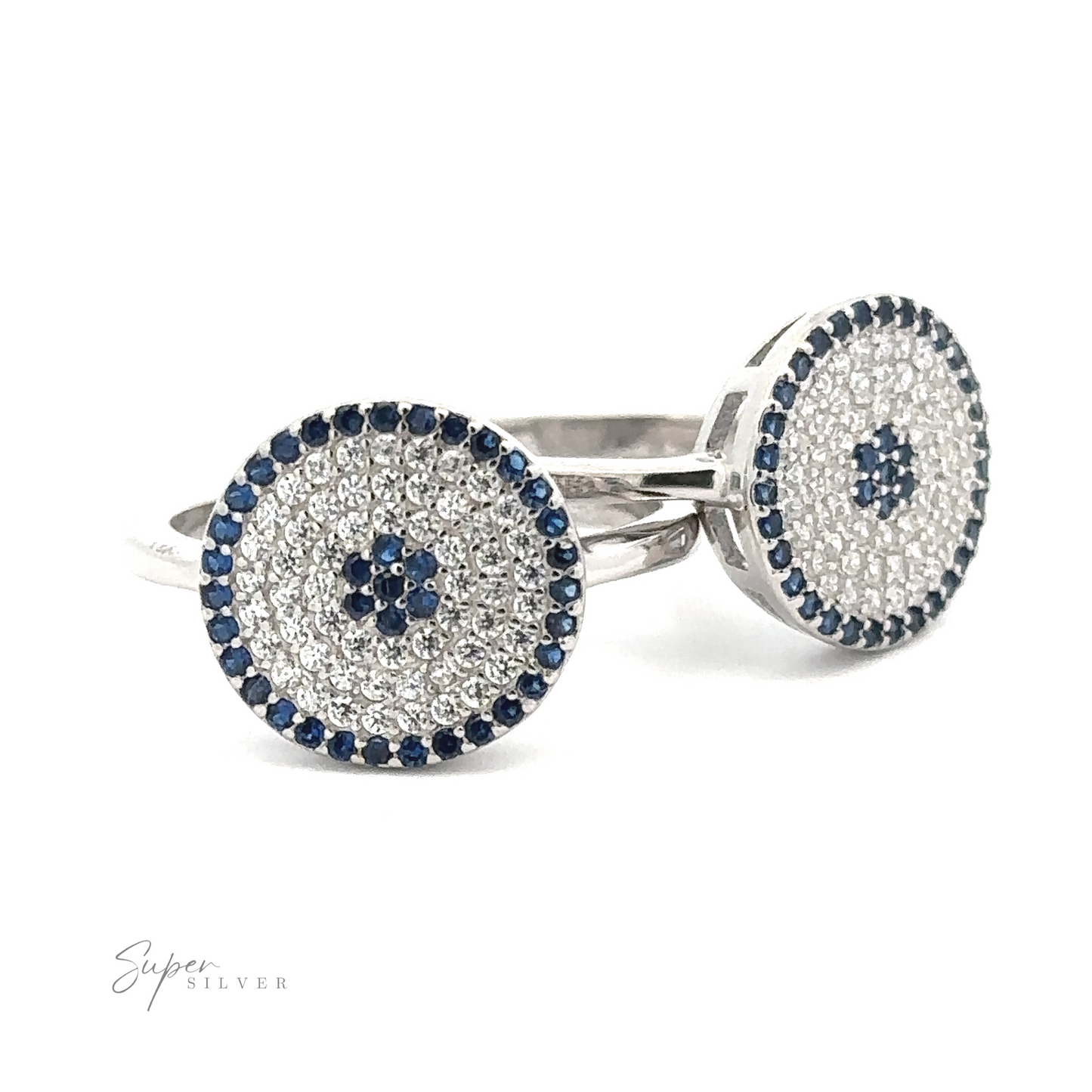 A pair of sterling silver rings featuring circular blue and white gemstone designs, reminiscent of a Cubic Zirconia Evil Eye Ring.