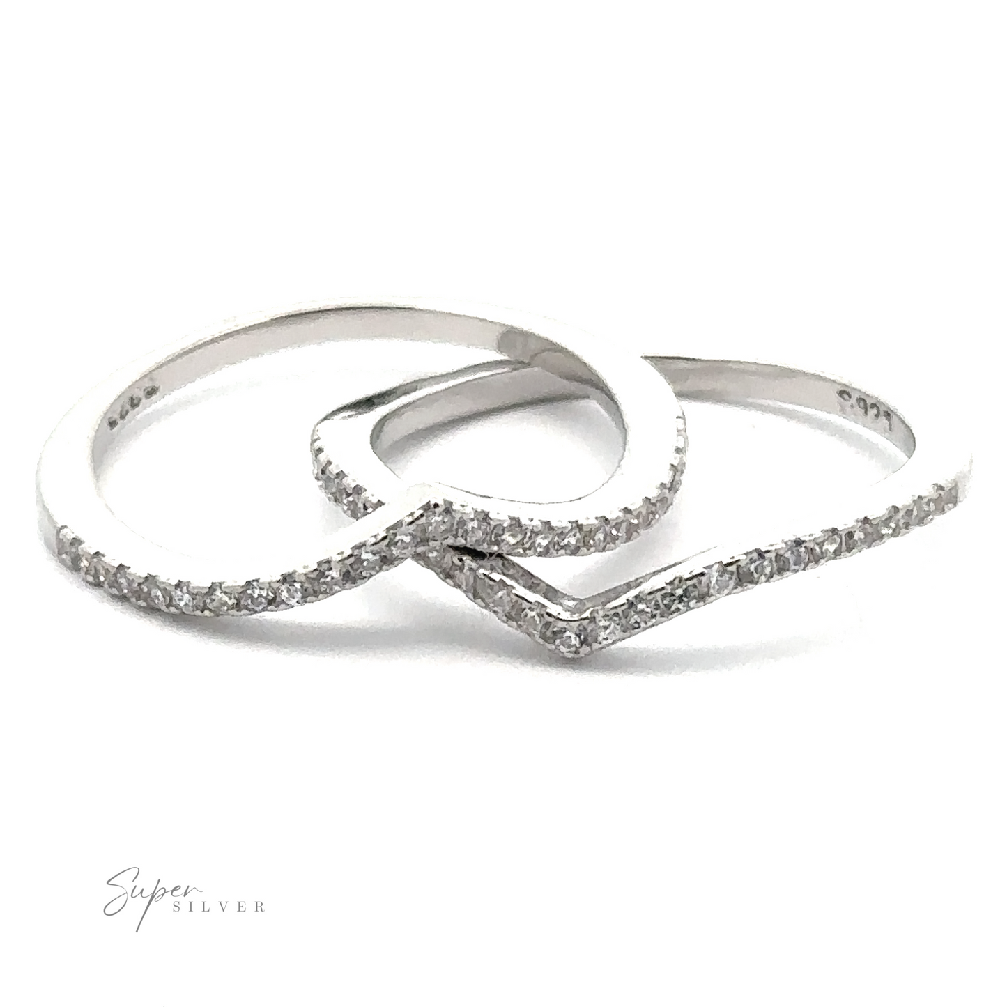 The Pave Cubic Zirconia Chevron Ring exudes modern elegance with its sterling silver bands adorned with small, evenly spaced cubic zirconia stones.