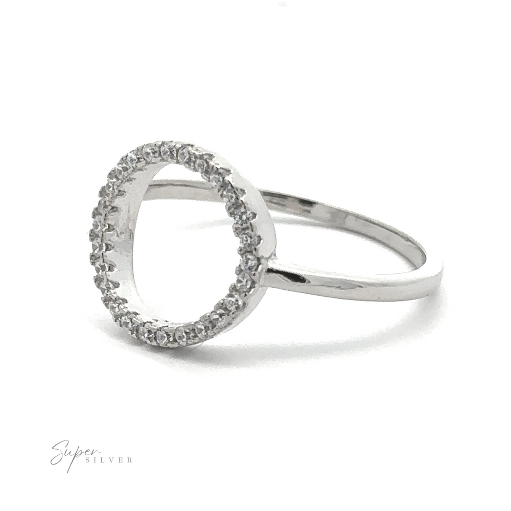 
                  
                    A silver ring exuding modern elegance, with an open circle design embellished with small, round cubic zirconia gemstones, positioned on a white background. The text "Modern Circular Pave Cubic Zirconia Ring" is visible in the lower-left corner.
                  
                