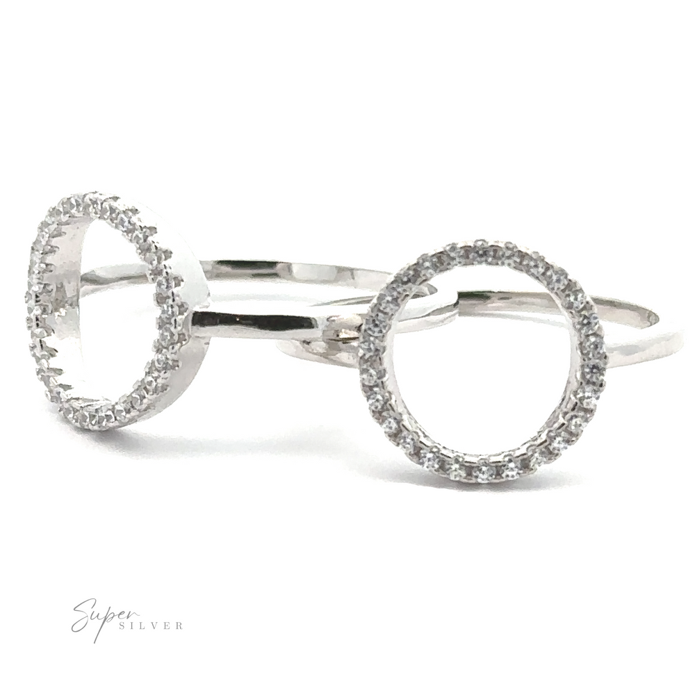 Two Modern Circular Pave Cubic Zirconia Rings, epitomizing modern elegance with their sterling silver composition and small white stones, are displayed on a white background with "Super Silver" branding in the corner.