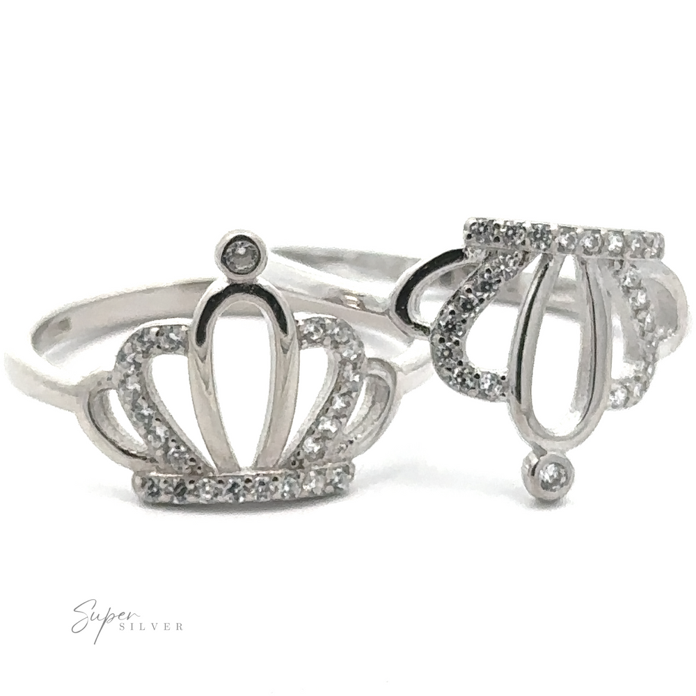 Two Cubic Zirconia Crown Rings, each adorned with a crown design and small, clear pavé cubic zirconia gemstones, positioned side by side against a white background. These are timeless statement pieces.