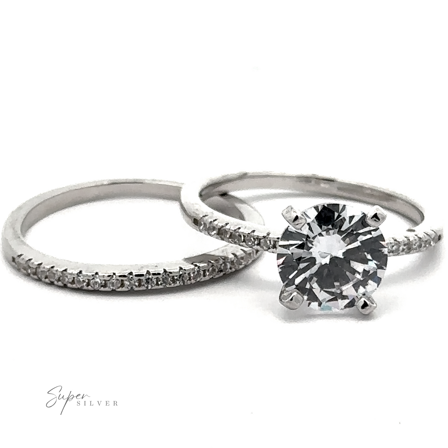 A set of two sterling silver rings with diamonds: one is a plain band with small pave accents, and the other showcases a large round diamond in a solitaire setting. Text reads "Round Cubic Zirconia Wedding Set Ring.