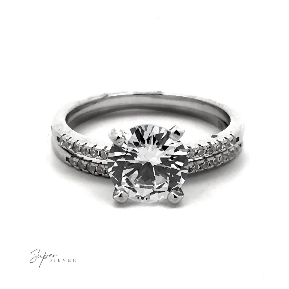 
                  
                    Round Solitaire Wedding Band Set in Sterling Silver Rhodium Finish featuring a large round diamond in a prong setting and pave accents along the band. The words "Super Silver" are visible in the bottom left corner.
                  
                