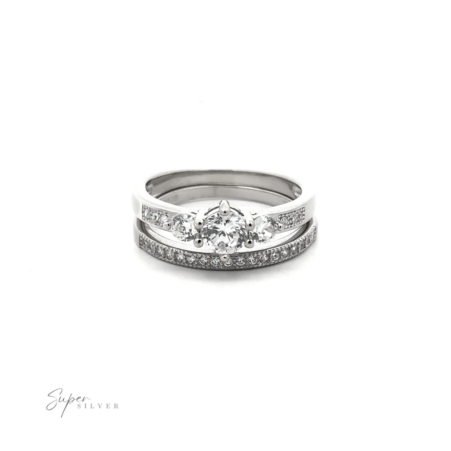 
                  
                    Discover the affordable Round Cubic Zirconia Wedding Band Set featuring a silver ring adorned with a central larger high-quality cubic zirconia stone and smaller stones on the band, complete with the "Super Silver" logo in the bottom left corner. Perfect for those seeking elegance without compromise.
                  
                