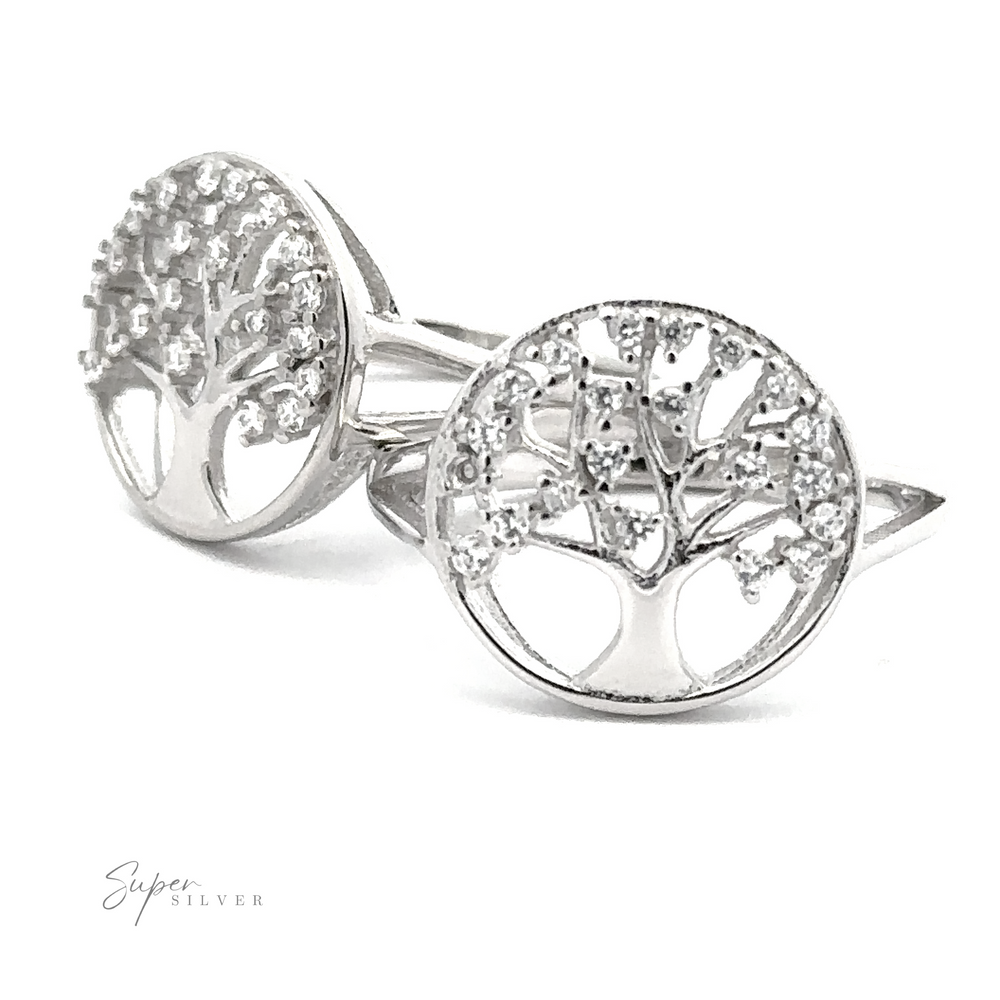 Two Tree Of Life Ring Cubic Zirconia Stones with intricate tree designs, adorned with delicate Cubic Zirconia stones, placed upright on a white background. The rings are labeled 