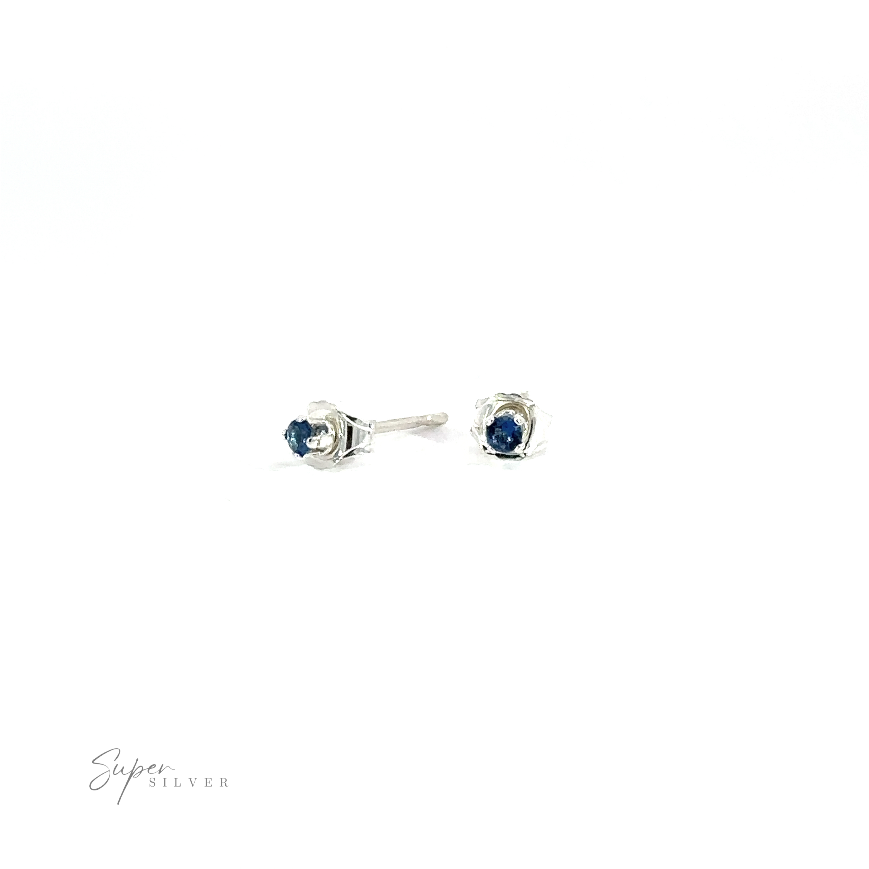 A pair of Round CZ Stud earrings with blue cubic zirconia gemstones against a white background.