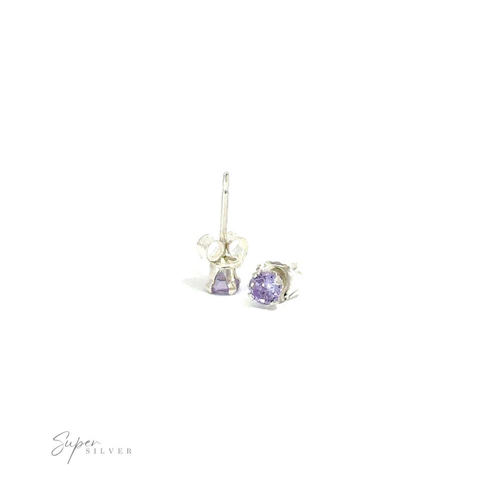 
                  
                    Round CZ stud earrings with purple cubic zirconia on a white background.
                  
                