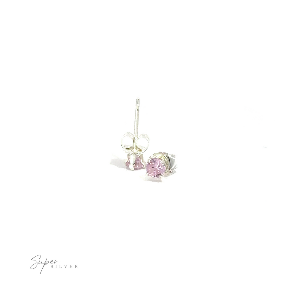 
                  
                    A pair of silver round CZ studs with pink cubic zirconia gemstones on a white background.
                  
                