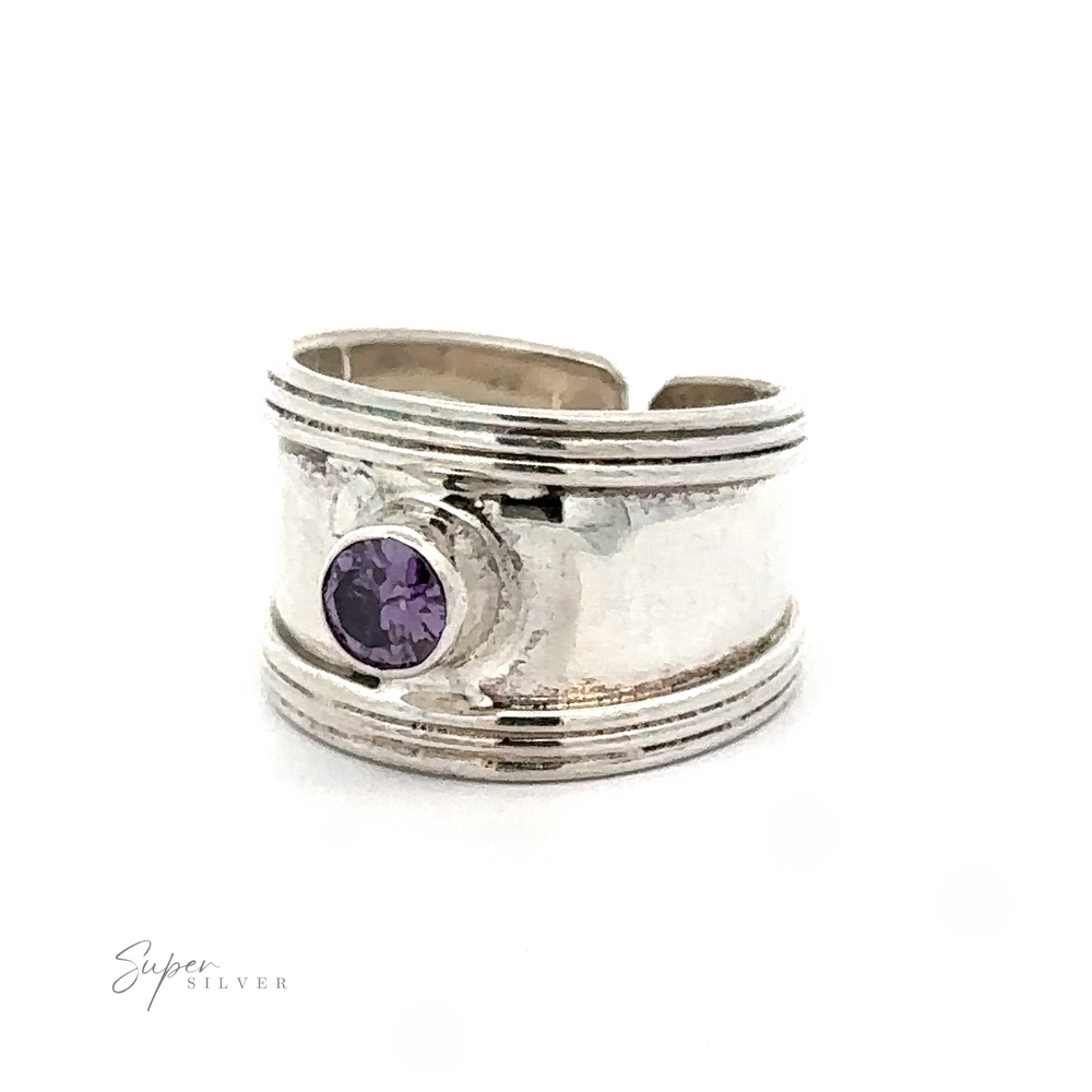 
                  
                    Adjustable Wide Cigar Band Toe Ring with Gemstone toe ring with a textured band and a small purple gemstone, displayed against a white background.
                  
                
