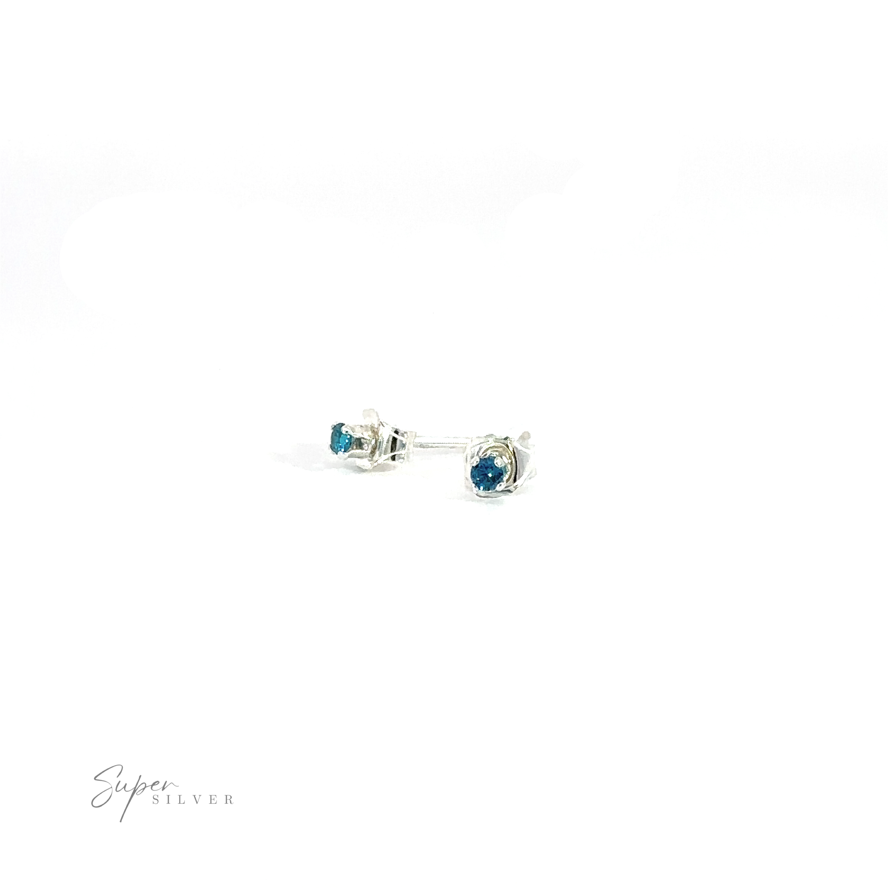 A pair of blue Round CZ stud earrings on a white background with the text "super silver" in a cursive font.