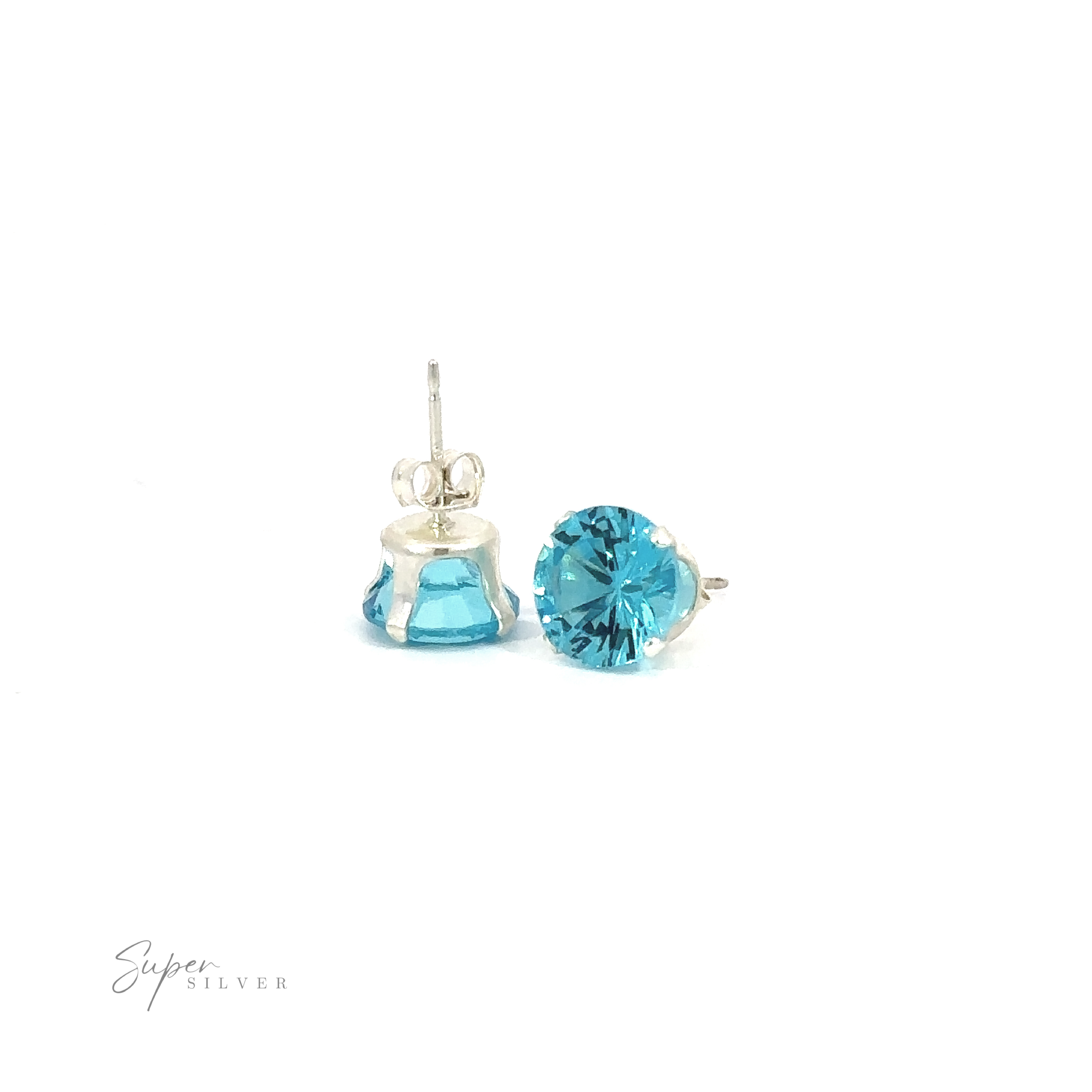 A pair of blue Round CZ Studs with silver settings on a white background.