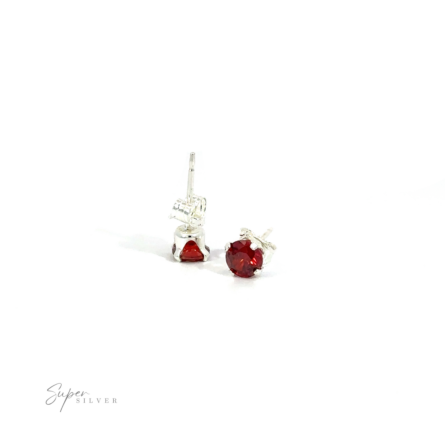 
                  
                    A pair of red round CZ stud earrings with silver settings on a white background.
                  
                