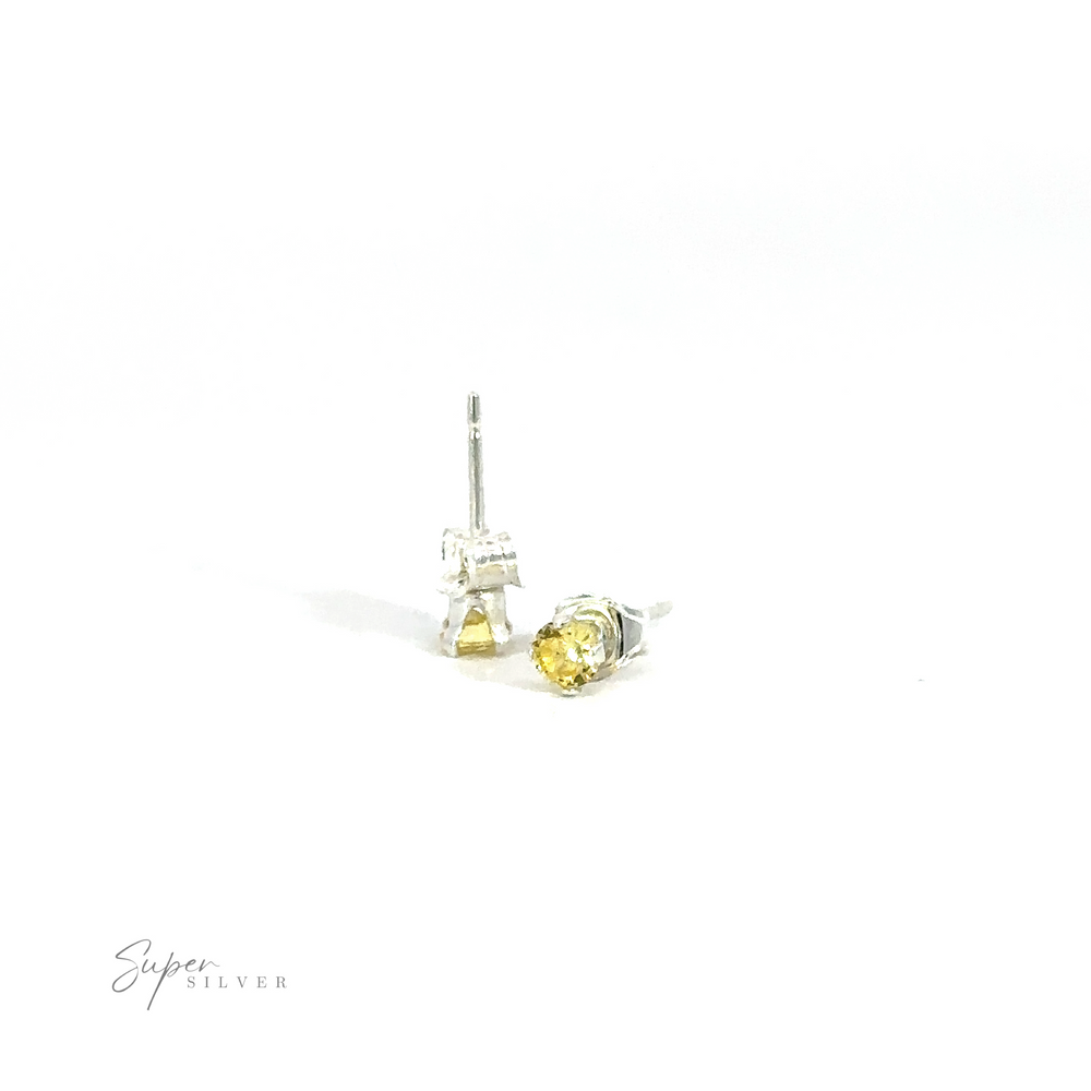 
                  
                    A pair of Round CZ Studs with yellow cubic zirconia gemstones on a white background.
                  
                