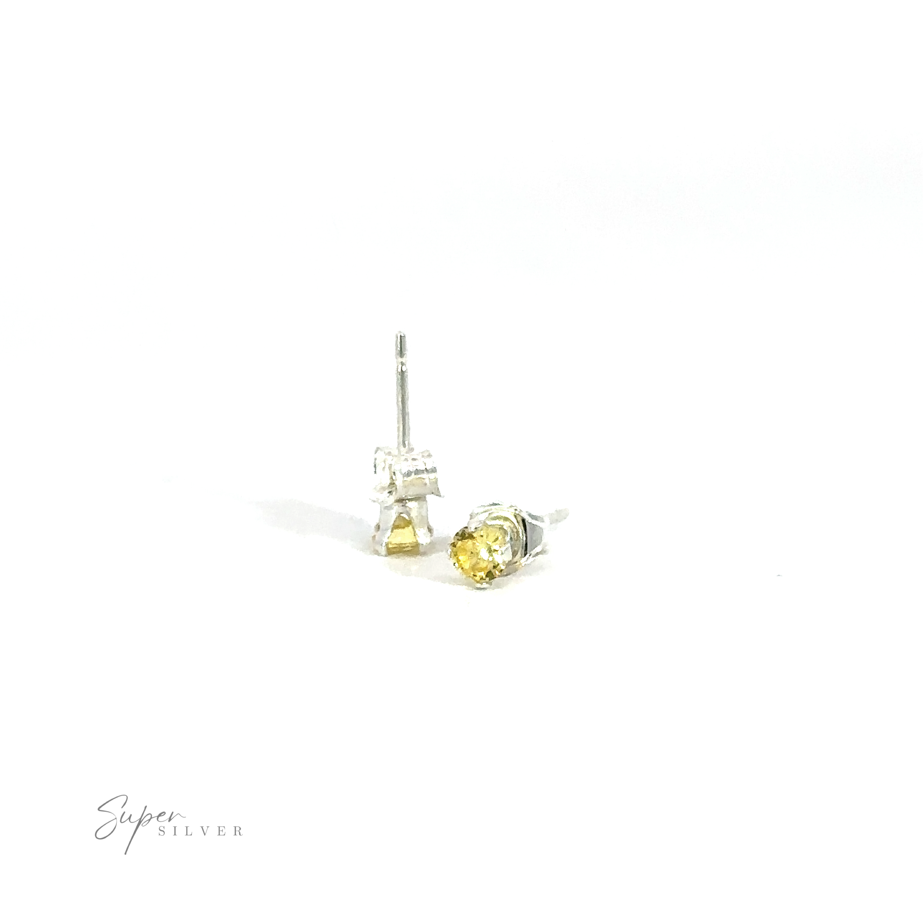 A pair of Round CZ Studs with yellow cubic zirconia gemstones on a white background.