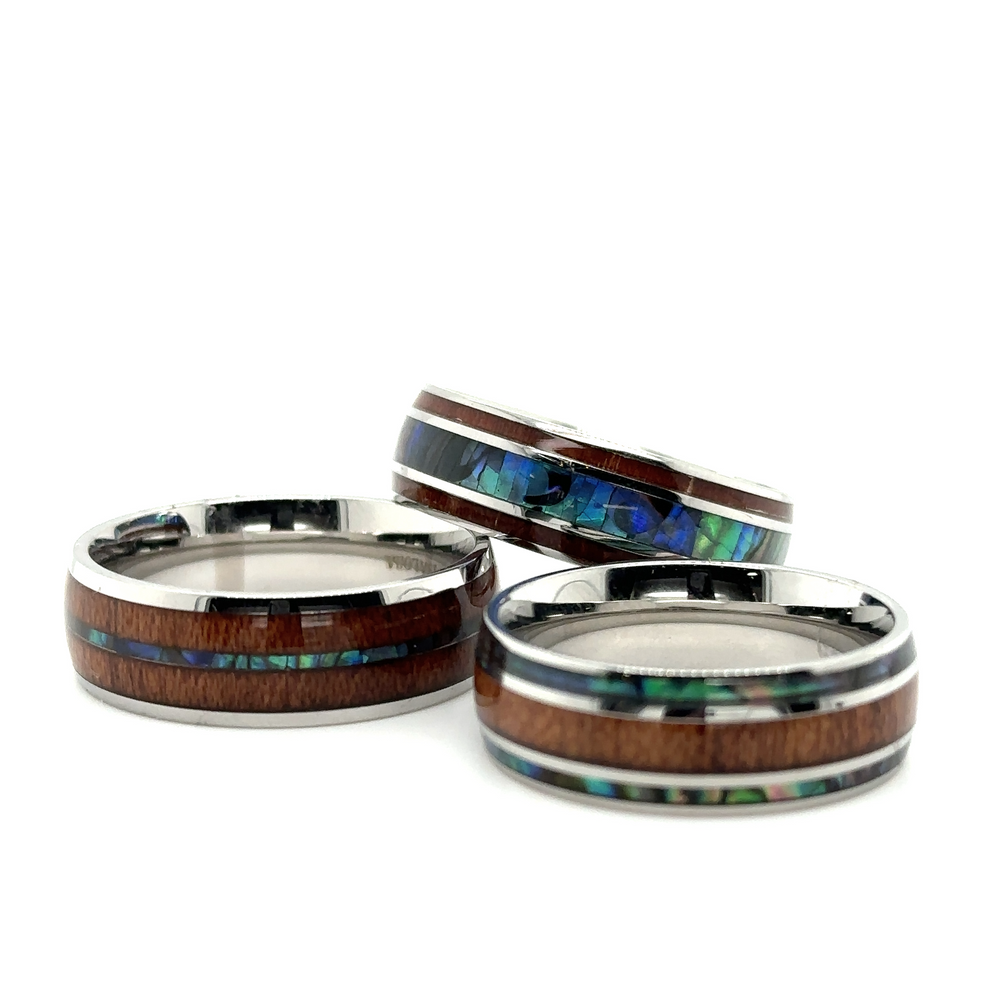 A set of three Abalone and Koa Wood Stainless Steel Rings with Super Silver inlays.
