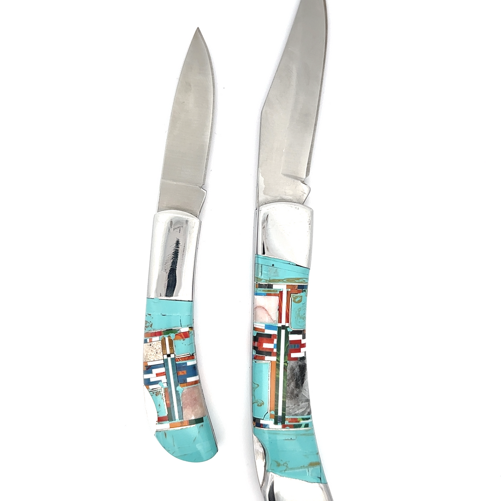 
                  
                    Two Intricate Inlay Southwest Pocket knives featuring turquoise inlay and multicolored handles. Knife A is shorter with a plain blade, while Knife B is longer with a slightly curved blade, exemplifying a distinct Southwest style.
                  
                