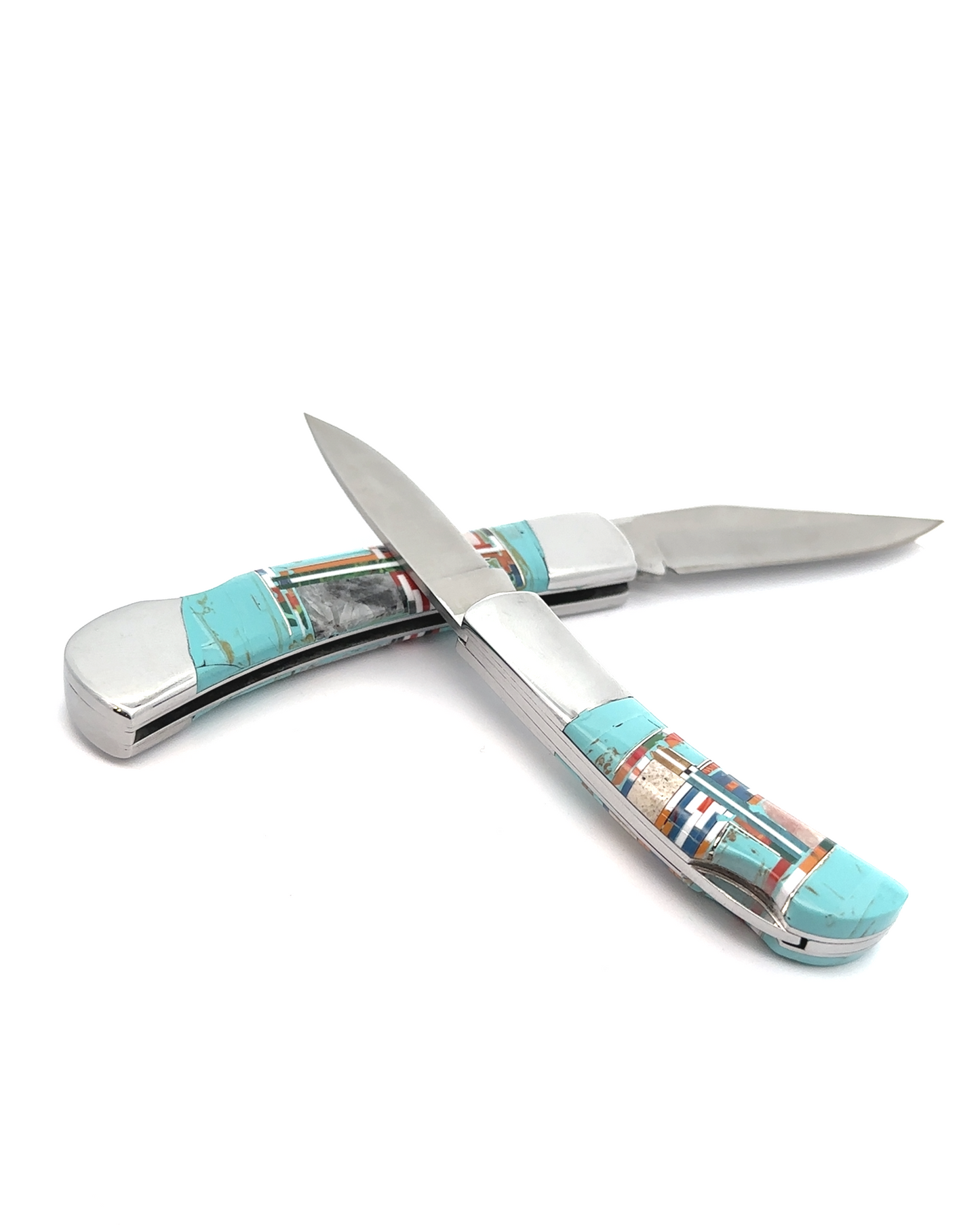 The "Intricate Inlay Southwest Pocket Knife," featuring turquoise and mosaic-patterned handles, showcases two blades open and crossed on a white background, embodying an elegant Southwest aesthetic.