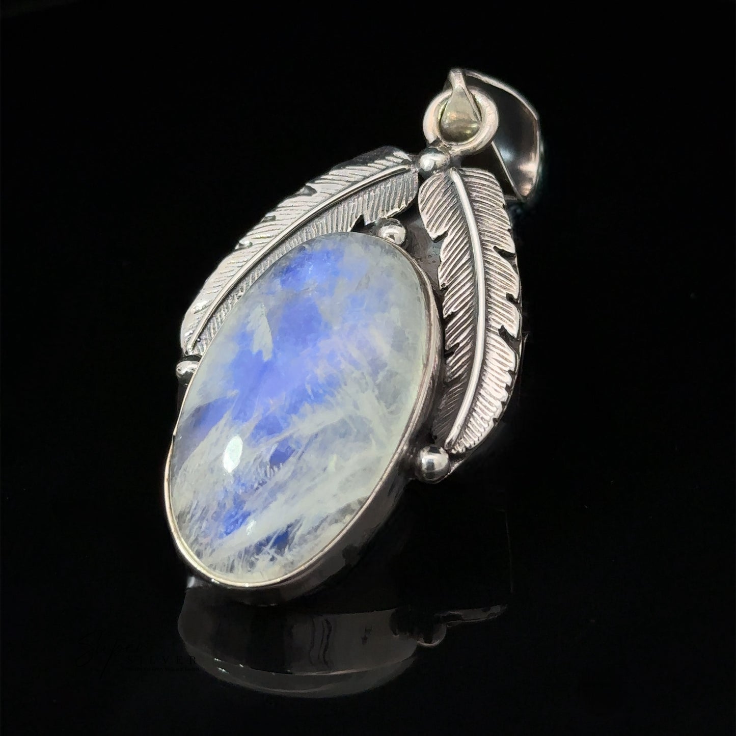 
                  
                    A Beautiful Southwest Stone Pendant featuring a large oval blue gemstone, set with two feather-shaped details, displayed on a black background.
                  
                