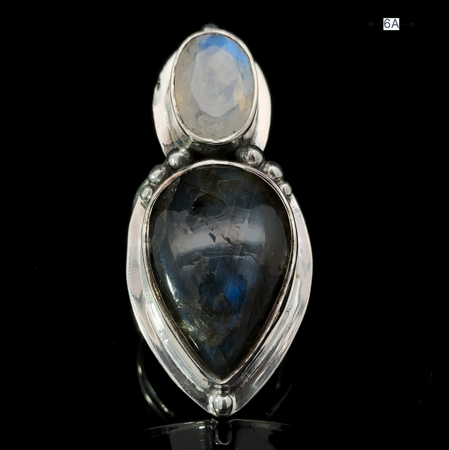 
                  
                    The Heavy Labradorite And Moonstone Ring is a stunning statement piece, featuring a captivating teardrop-shaped dark blue labradorite gemstone set below a smaller, round light blue moonstone.
                  
                