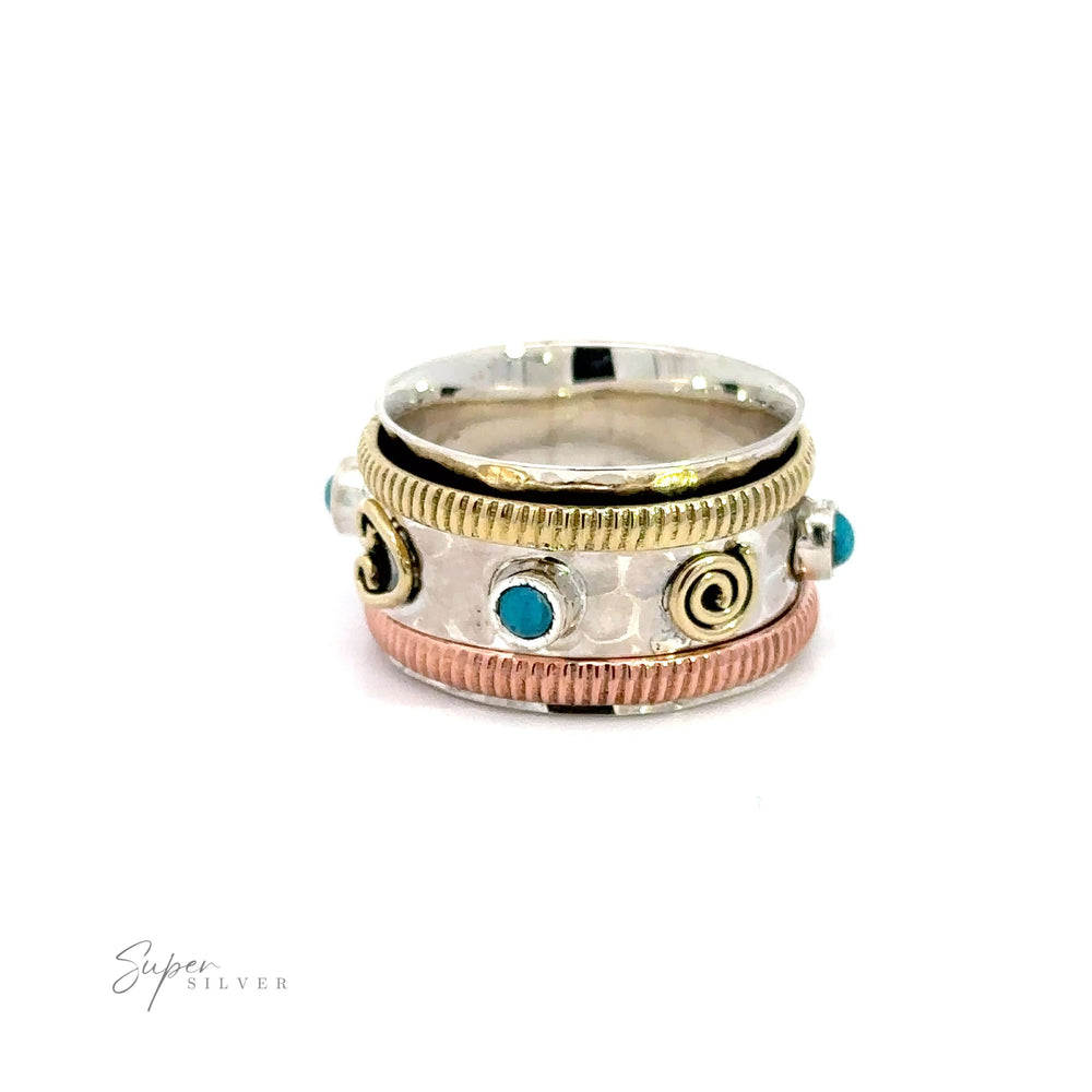 A Handmade Tricolor Turquoise Spinner Ring featuring turquoise stones.