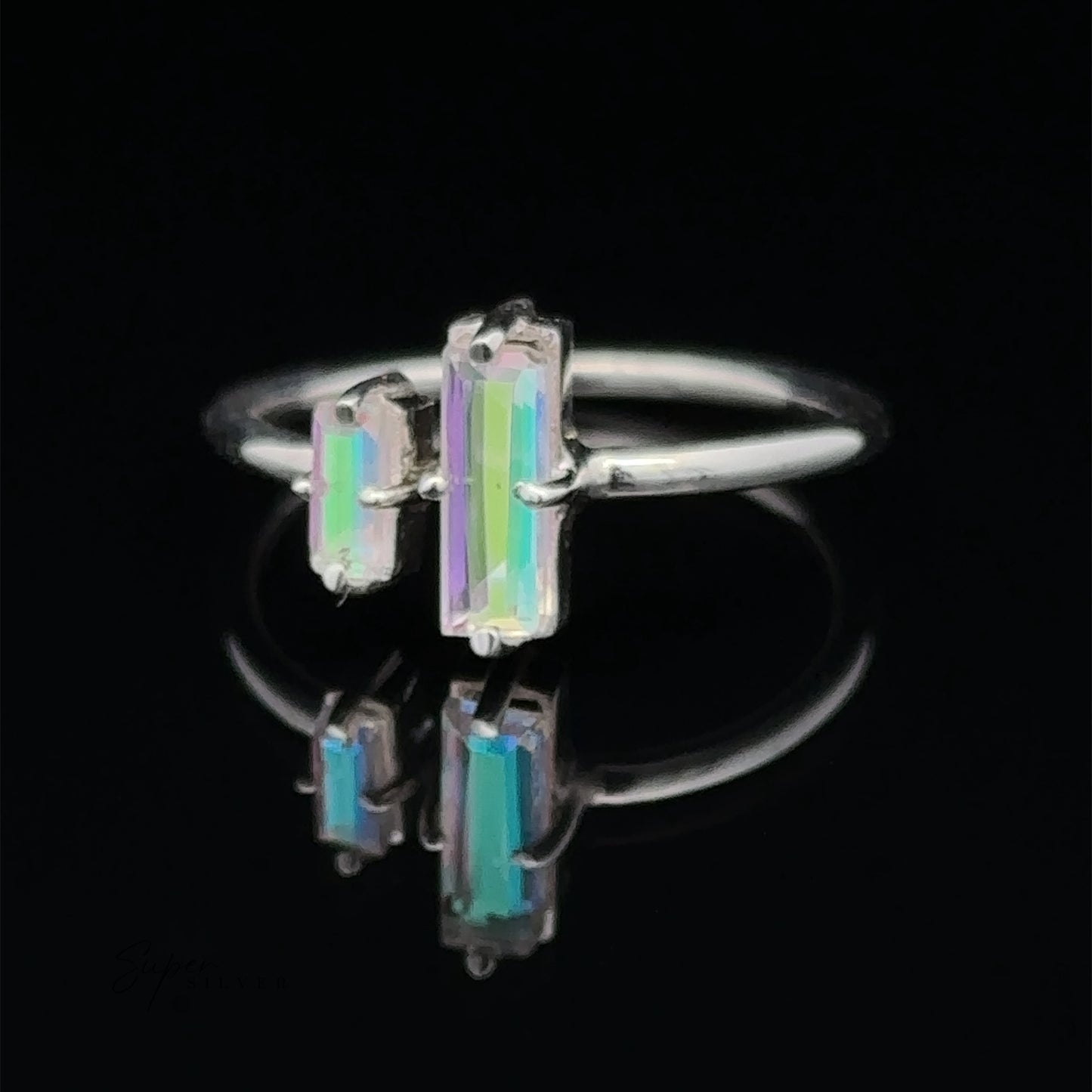 The Online Only Exclusive Adjustable Crystal Ring features three vertical, rectangular, multi-colored gemstones displayed against a dark background with a reflection below.