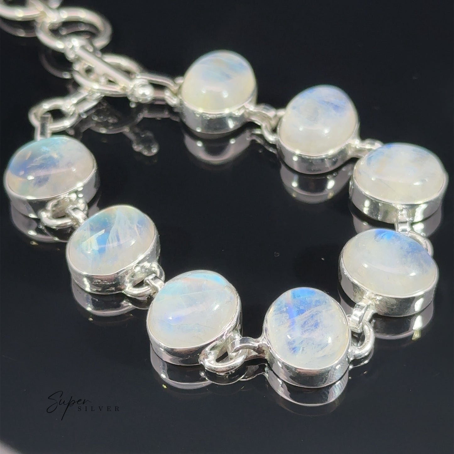 
                  
                    Statement Oval Gemstone Bracelets featuring round opal stones set in a linked gemstone bracelet design, displayed on a dark reflective surface.
                  
                