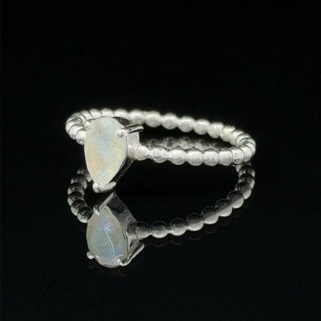 
                  
                    Sparkling Teardrop Opal Gemstone on Beaded Band with a black background.
                  
                