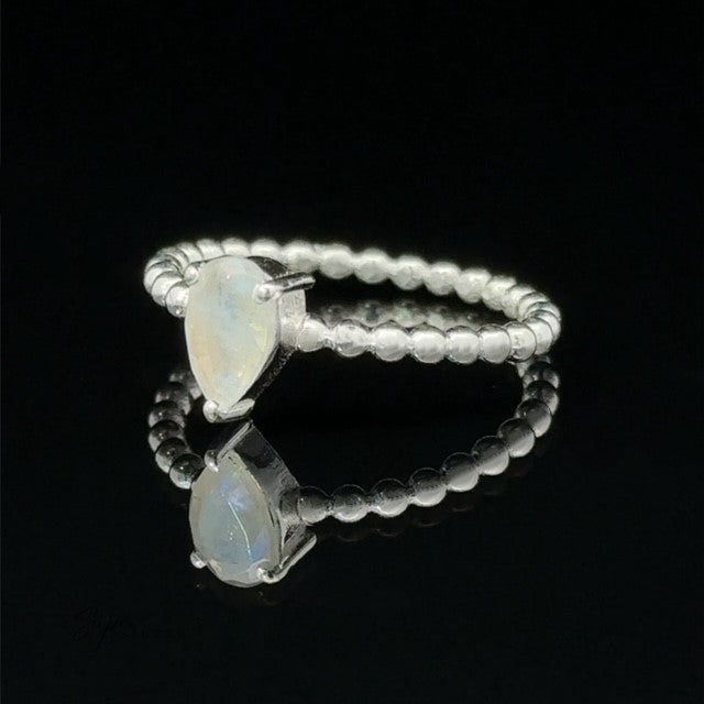 Sparkling Teardrop Opal Gemstone on Beaded Band with a black background.