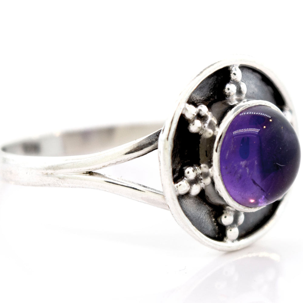 
                  
                    A Gemstone Ring With Unique Oxidized Design featuring a round, polished purple gemstone set in the center of a circular, detailed design that showcases the beauty of oxidized silver.
                  
                