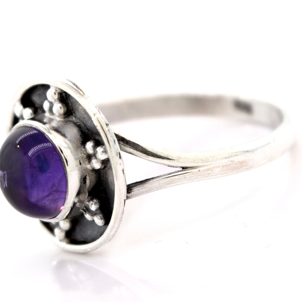 
                  
                    A Gemstone Ring With Unique Oxidized Design featuring a round purple gemstone set in a decorative bezel, exemplifying the elegance of gemstone jewelry in stunning sterling silver.
                  
                