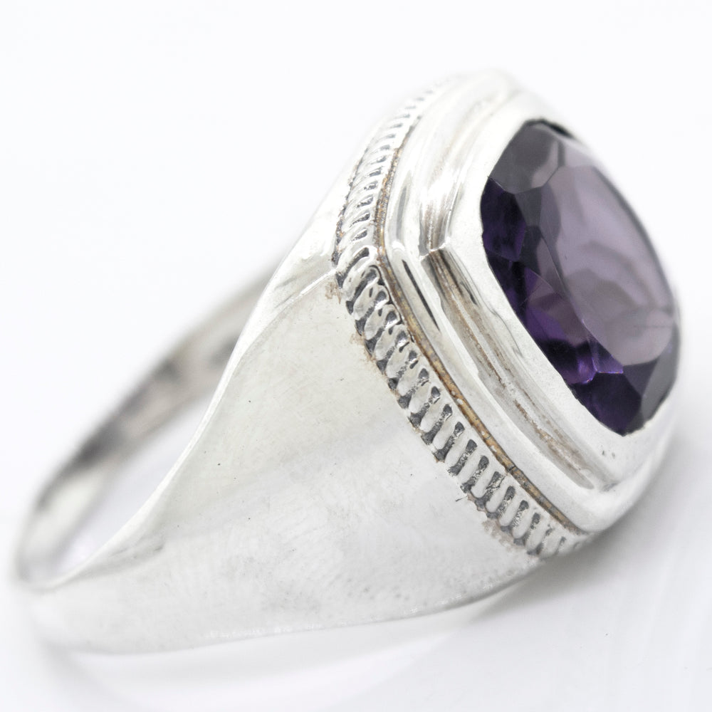 
                  
                    A Faceted Stone Signet Ring with a large oval-shaped amethyst gemstone set in a raised bezel on a white background.
                  
                
