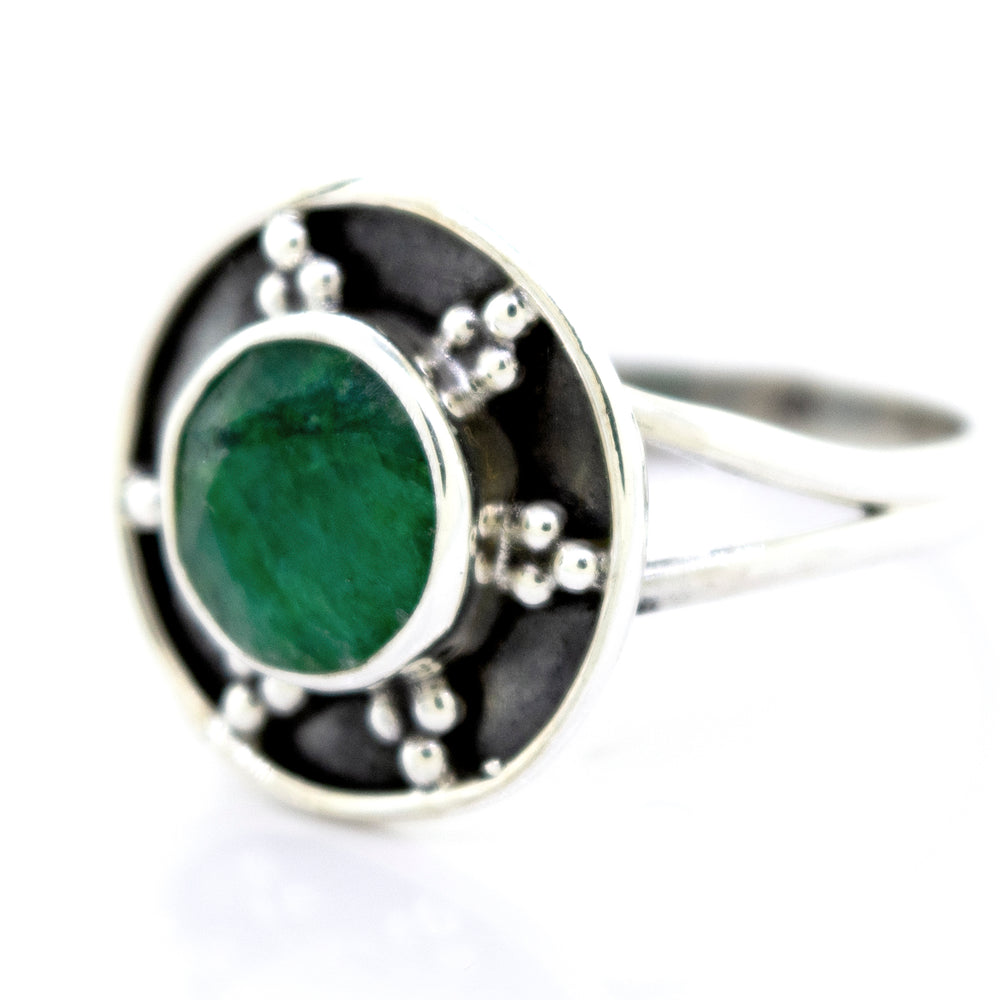 
                  
                    A Gemstone Ring With Unique Oxidized Design featuring a green gemstone set in a circular design adorned with small decorative oxidized silver beads.
                  
                