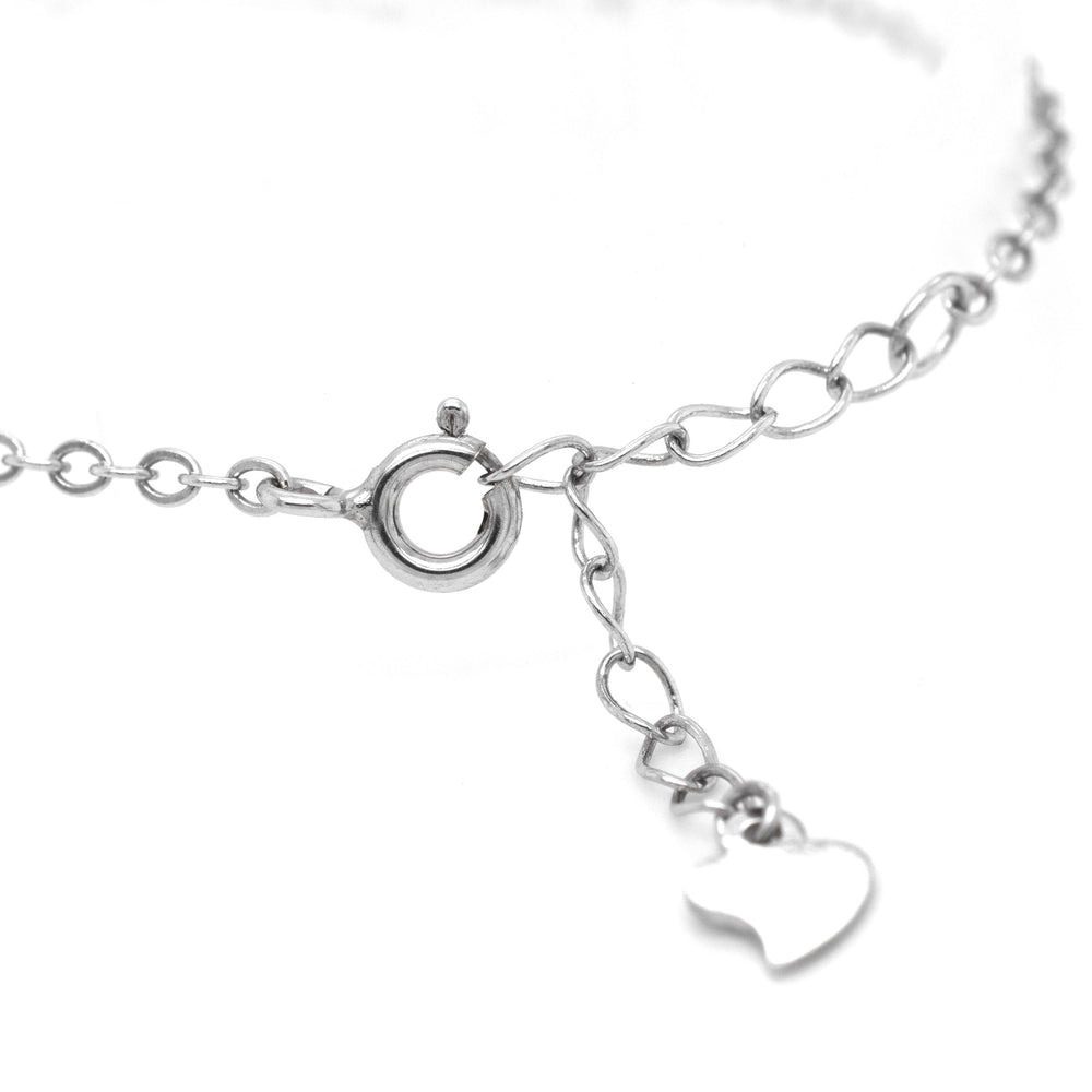 
                  
                    A close-up image of a Delicate Cubic Zirconia Evil Eye Bracelet featuring a ring clasp and a small heart-shaped charm adorned with cubic zirconia dangling from it.
                  
                