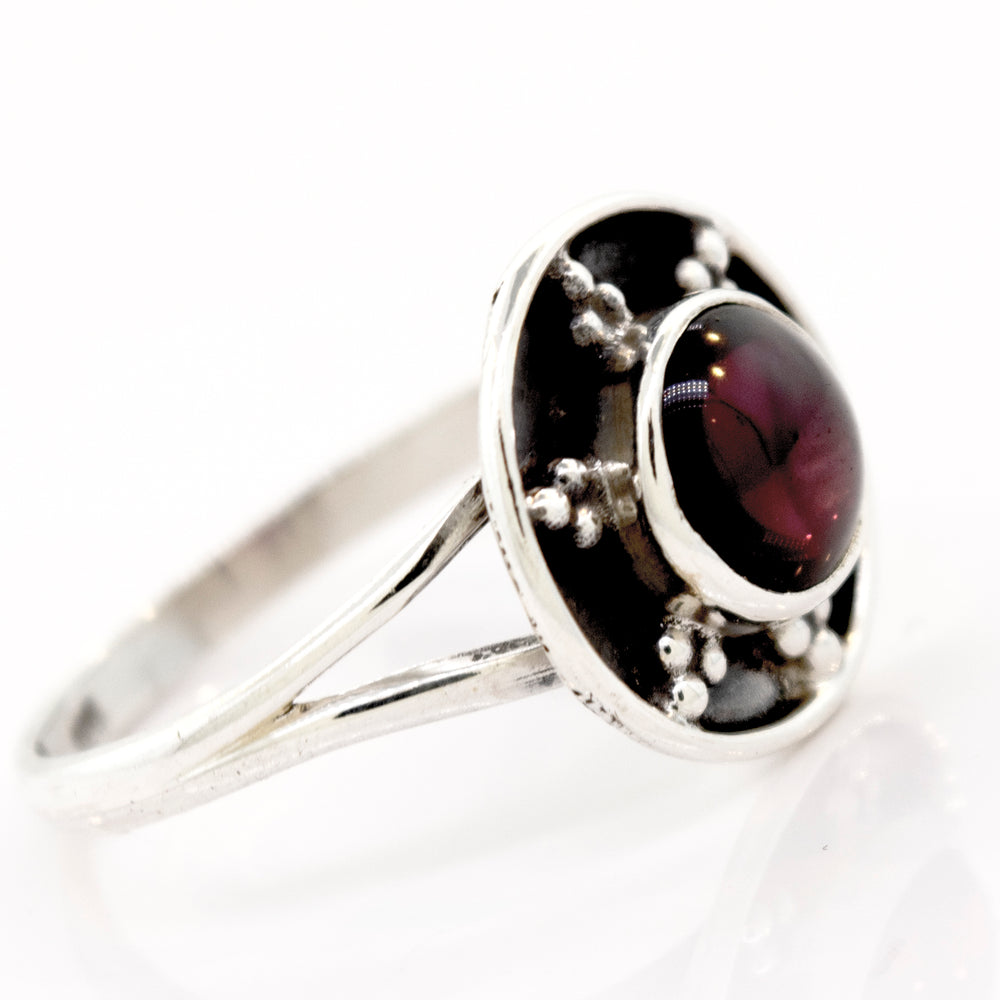 
                  
                    A **Gemstone Ring With Unique Oxidized Design** with a round, deep red gemstone set in the center, featuring small decorative silver beads around the stone. This exquisite piece of gemstone jewelry radiates elegance and timeless charm.
                  
                