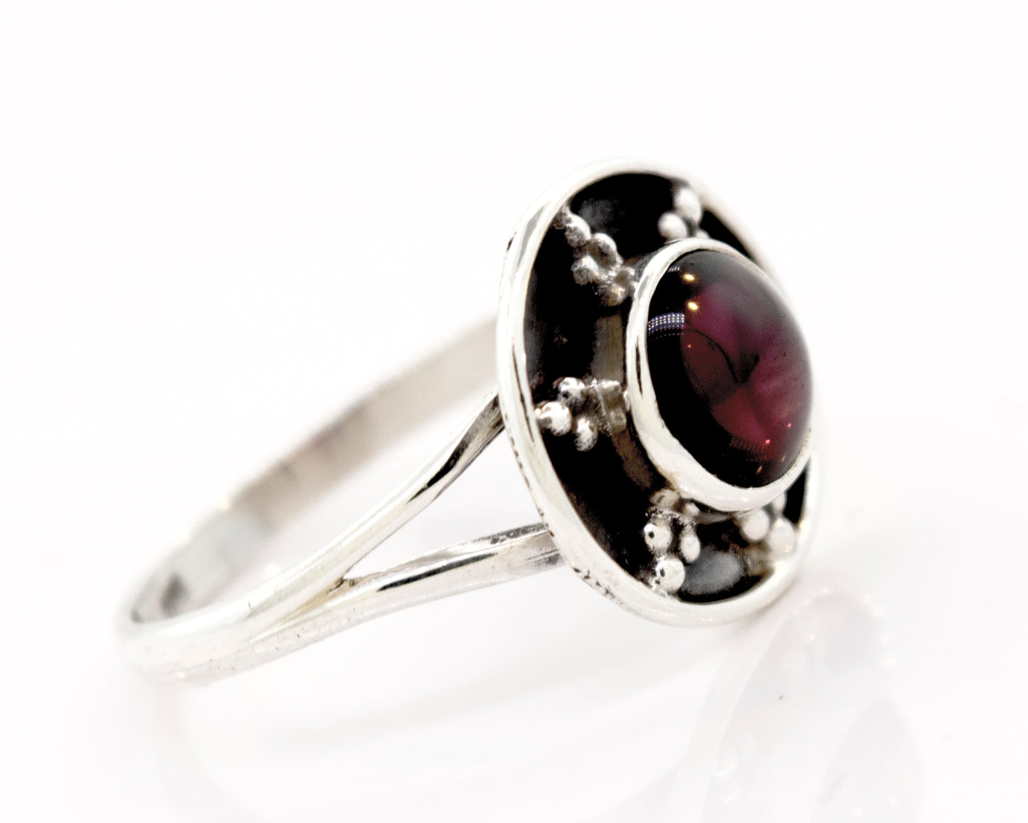 
                  
                    A **Gemstone Ring With Unique Oxidized Design** with a round, deep red gemstone set in the center, featuring small decorative silver beads around the stone. This exquisite piece of gemstone jewelry radiates elegance and timeless charm.
                  
                