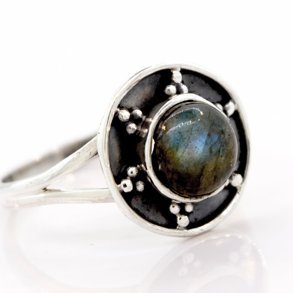 
                  
                    A Gemstone Ring With Unique Oxidized Design featuring a round, dark gemstone at its center, surrounded by an intricate oxidized silver design with small bead accents.
                  
                
