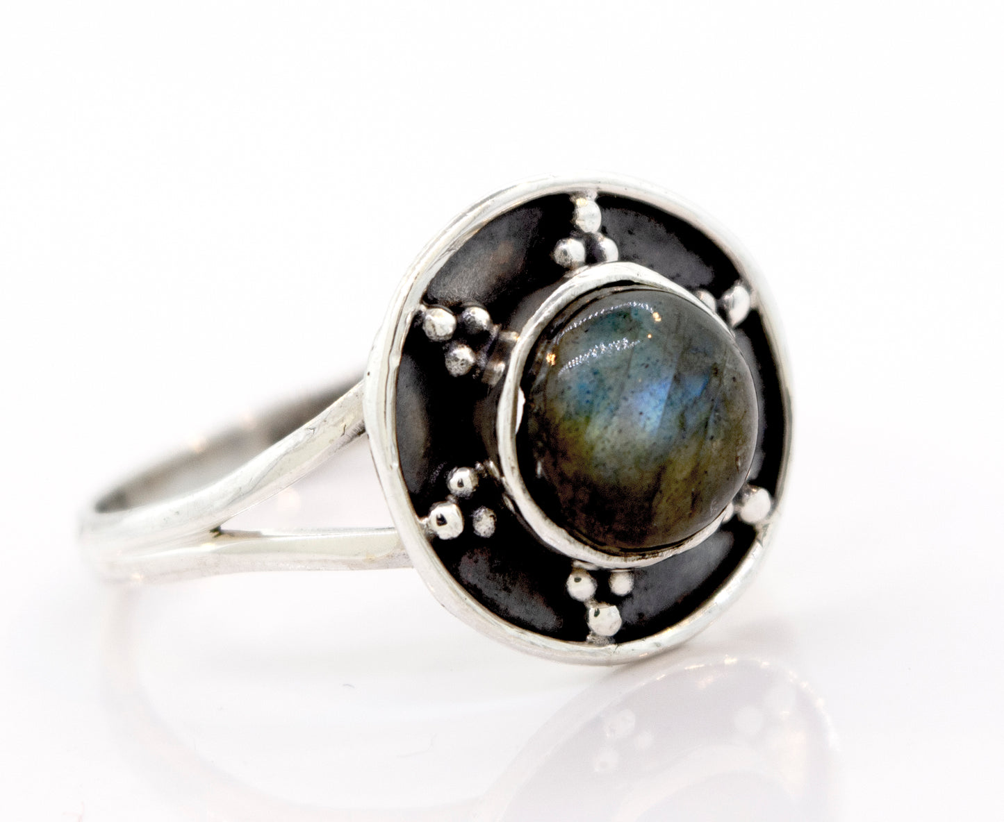 
                  
                    A Gemstone Ring With Unique Oxidized Design featuring a round, dark gemstone at its center, surrounded by an intricate oxidized silver design with small bead accents.
                  
                