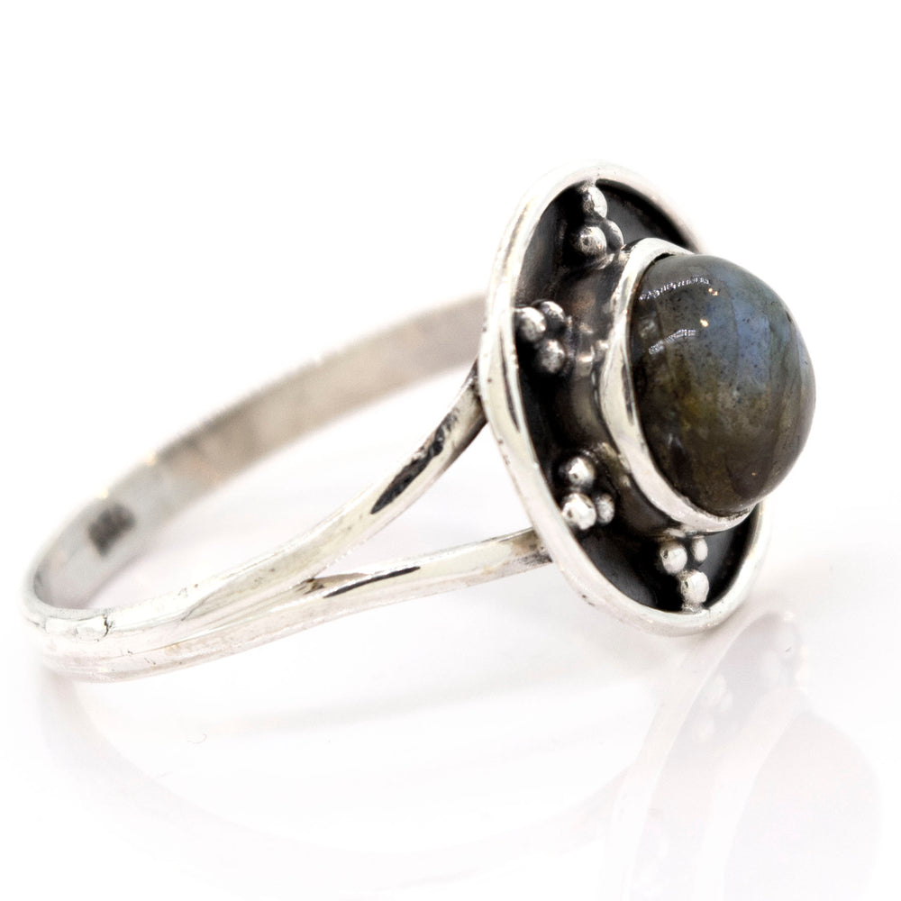 
                  
                    A Gemstone Ring With Unique Oxidized Design featuring a round, dark gemstone set in a raised circular design with small silver bead accents, exemplifying exquisite gemstone jewelry.
                  
                