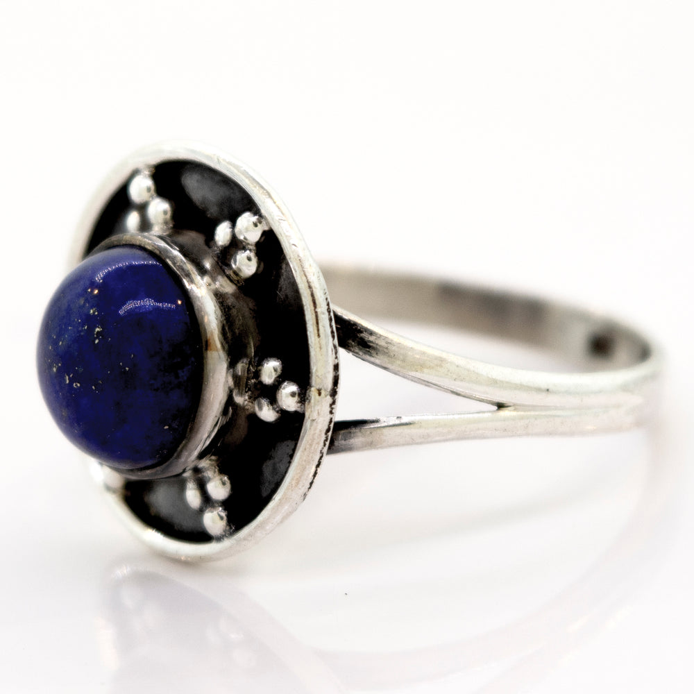 
                  
                    A Gemstone Ring With Unique Oxidized Design featuring a round, dark blue gemstone set in an ornate circular setting with small decorative oxidized silver beads.
                  
                