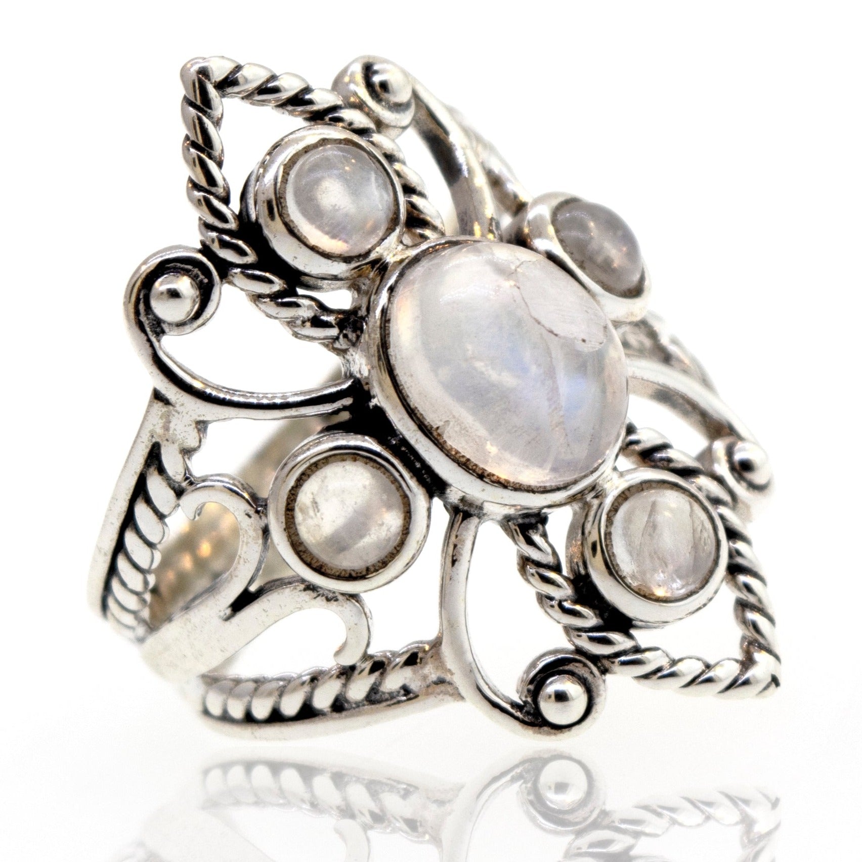 An ornate sterling silver ring featuring multiple moonstones set in an intricate, vintage design with filigree details.