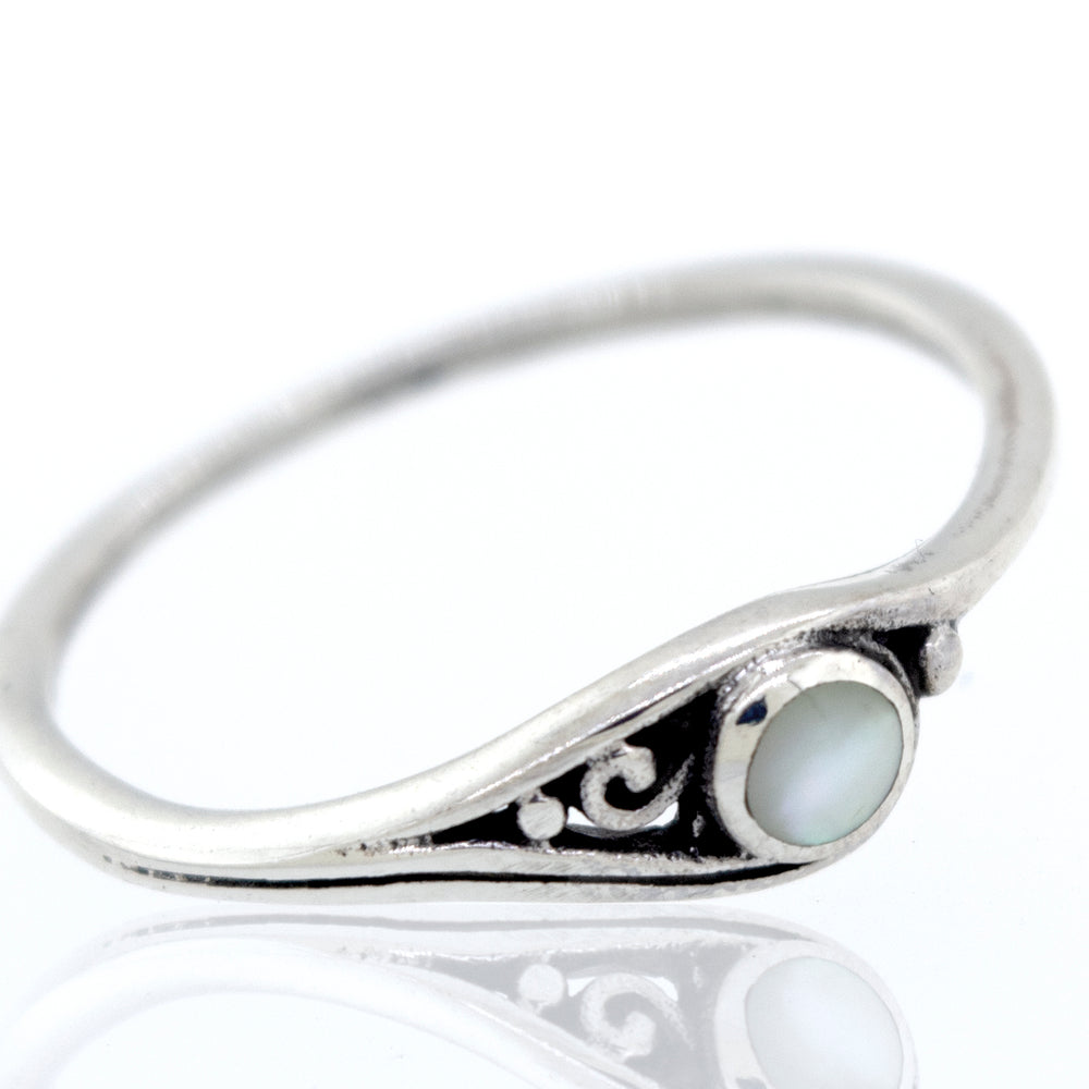 
                  
                    A Delicate Inlay Stone Ring with Small Swirl Design with inlaid mother of pearl.
                  
                