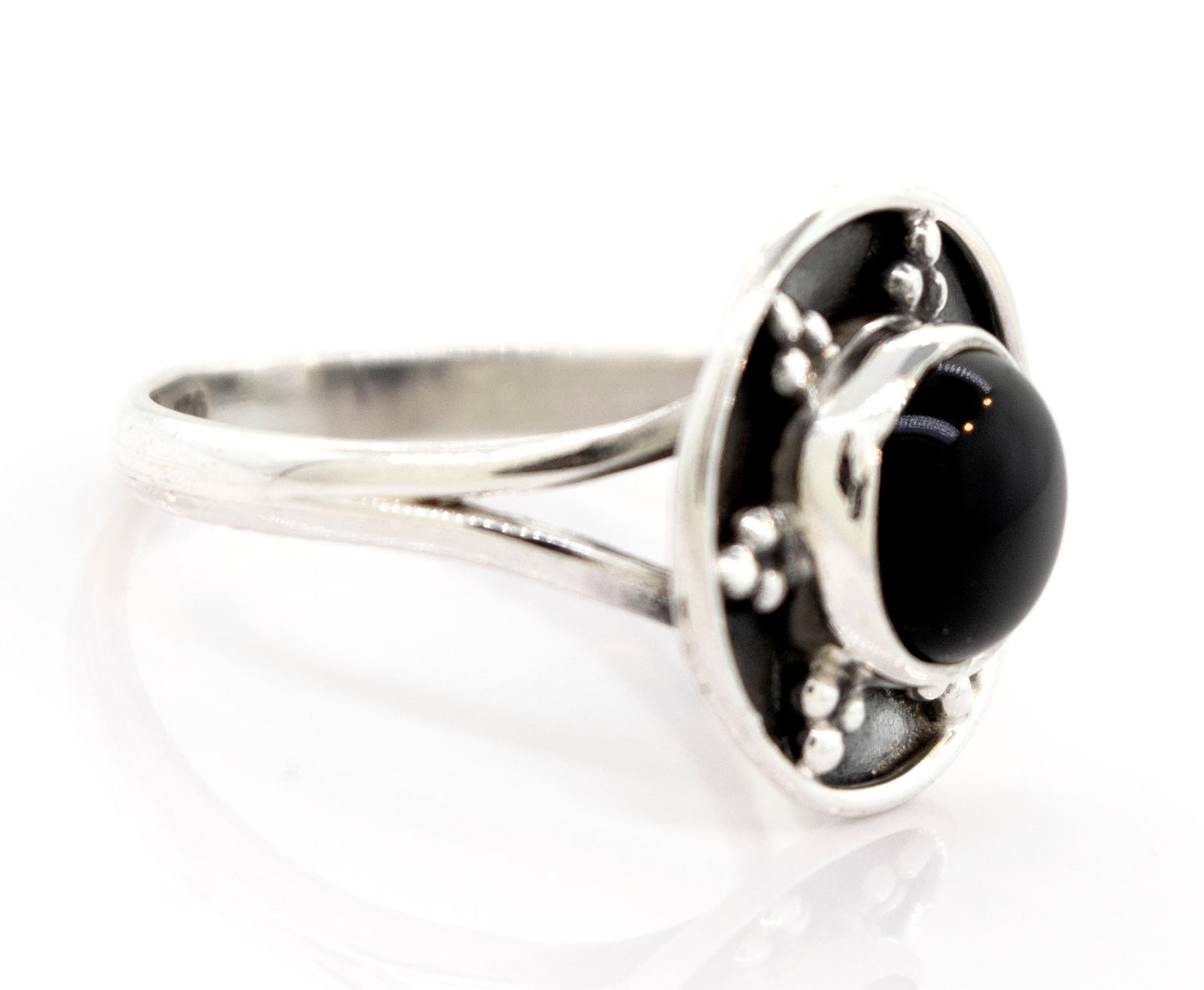 
                  
                    A Gemstone Ring With Unique Oxidized Design with a round black stone at its center, featuring a raised circular setting with small decorative elements around the stone.
                  
                