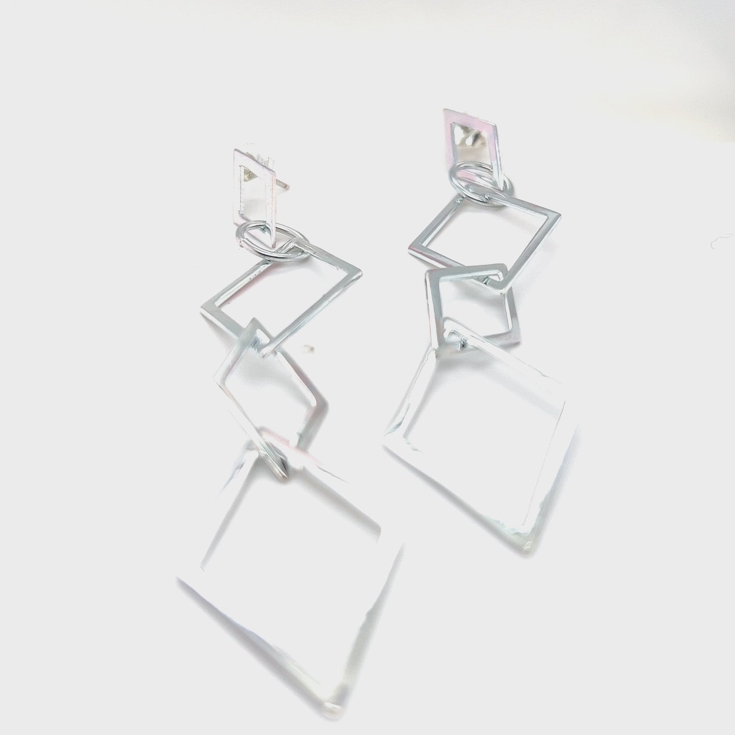 
                  
                    Load and play video in Gallery viewer, Long Interconnected Diamond Shaped Earrings
                  
                