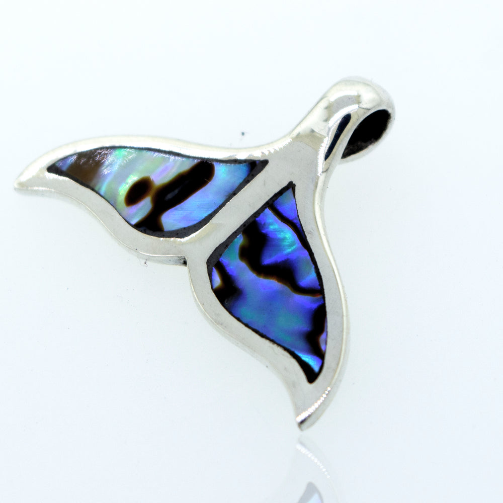 
                  
                    A stunning Inlay Whale Tail pendant crafted from sterling silver and resting on a serene white surface, made by Super Silver.
                  
                