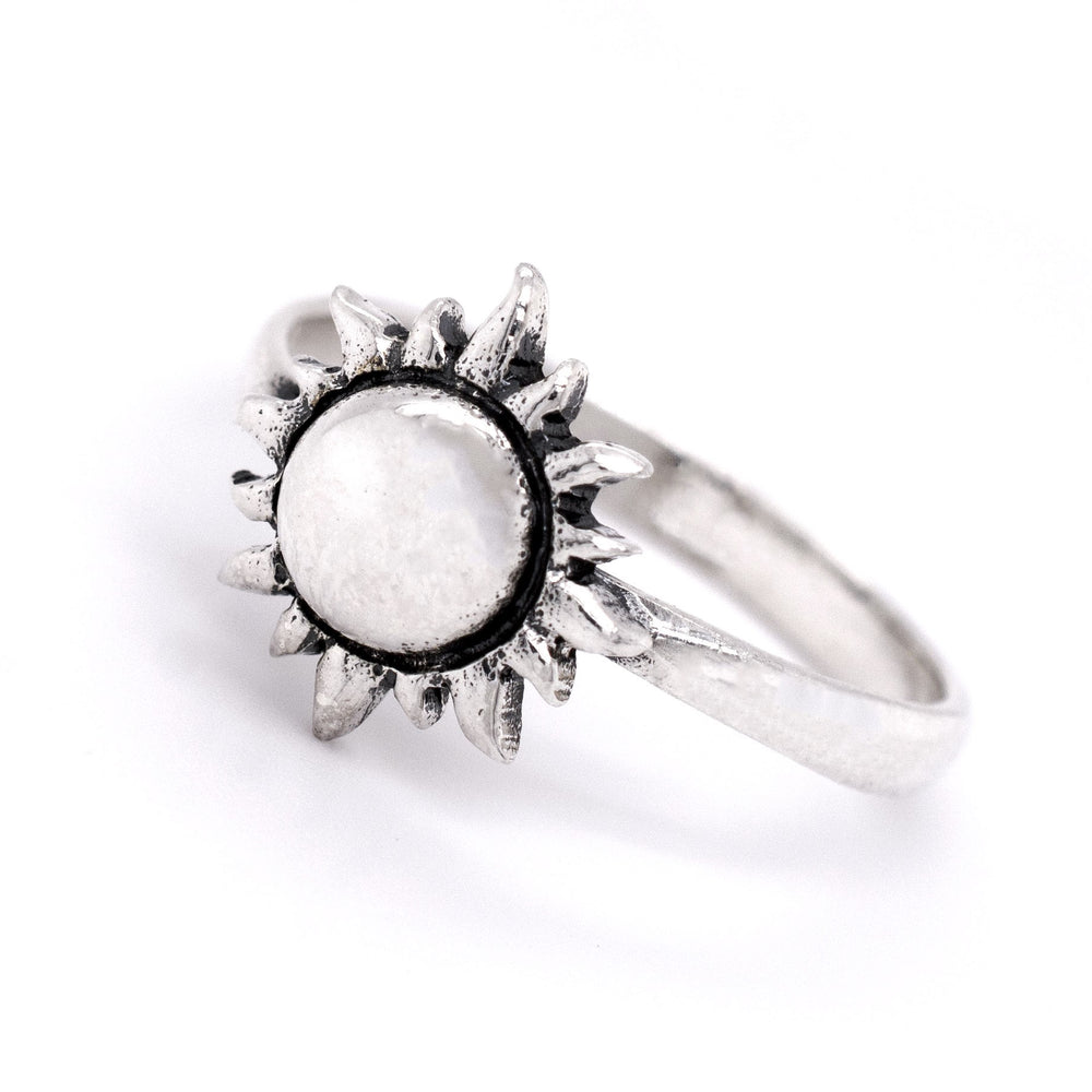 
                  
                    The Silver Sun Ring is a minimalist piece made from .925 Sterling Silver, featuring a sun-shaped design with a round, white stone in the center.
                  
                