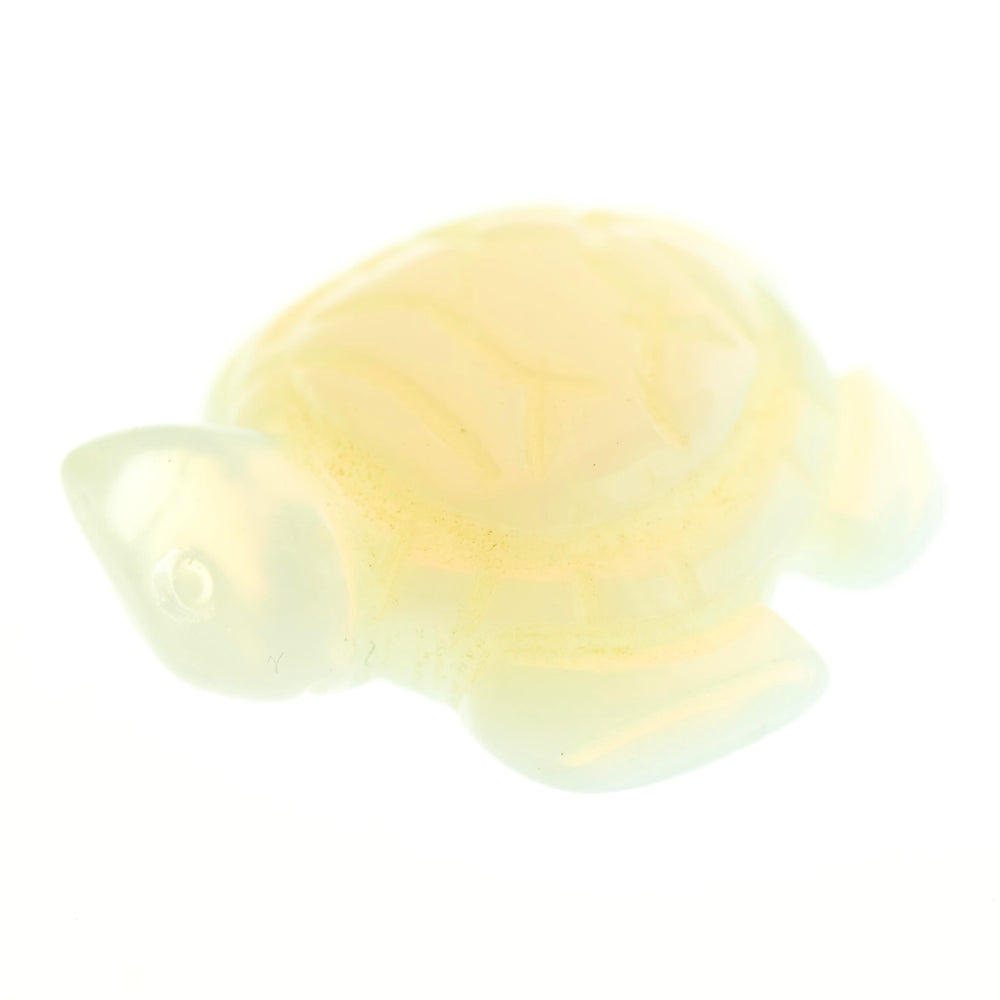 A small, translucent Carved Turtle Gemstone Figure resembling a turtle, displayed against a white background. The figure appears to be crafted from glossy aventurine or rose quartz.