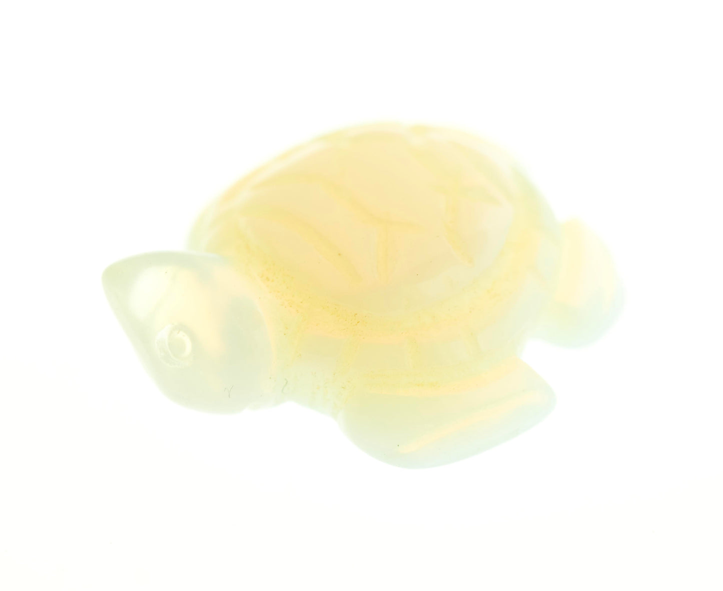 A small, translucent Carved Turtle Gemstone Figure resembling a turtle, displayed against a white background. The figure appears to be crafted from glossy aventurine or rose quartz.