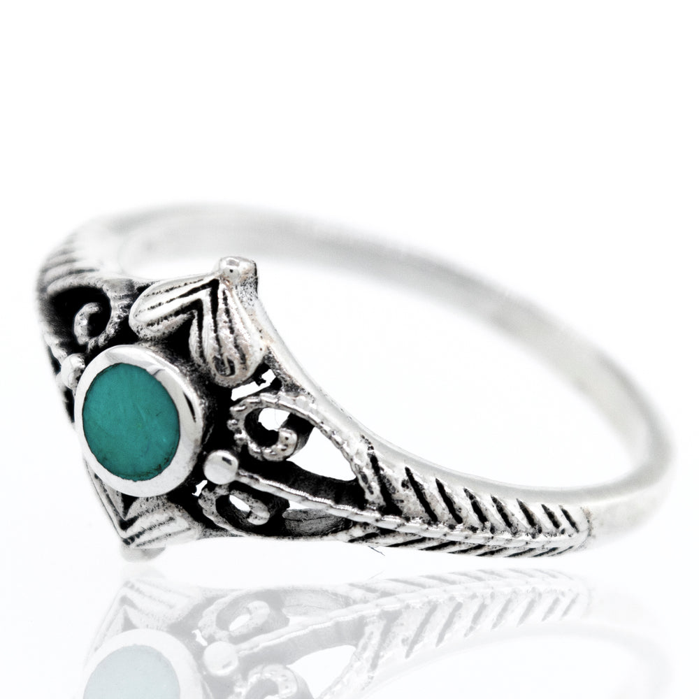 
                  
                    An Inlaid Stone Diamond Shaped Ring with Filigree Accents with a turquoise stone.
                  
                