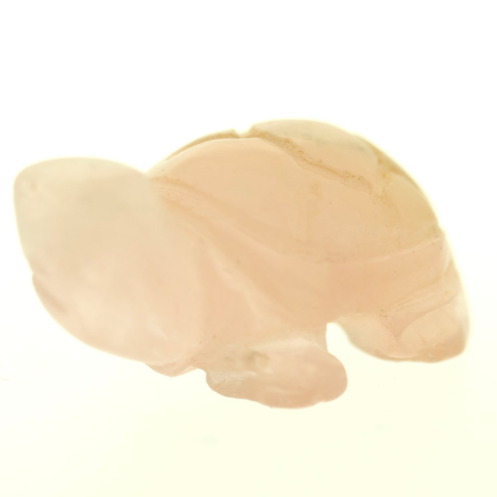 
                  
                    A small, light pink Carved Turtle Gemstone Figures made of Rose Quartz against a white background.
                  
                